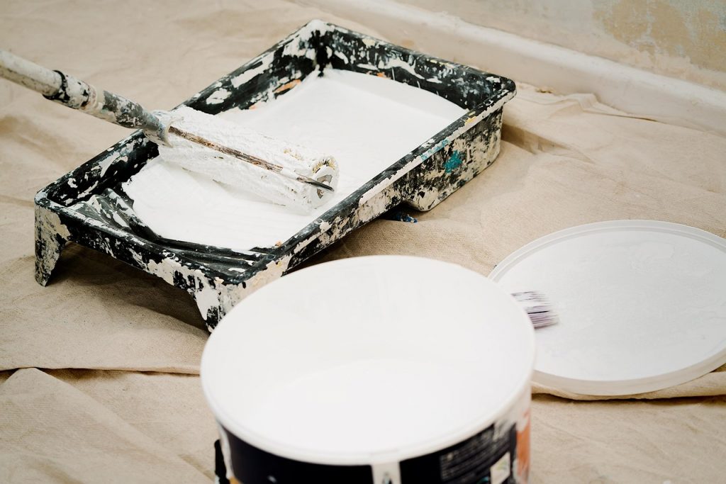 Home Interior home painting tools and paint buckets on a wooden floor
