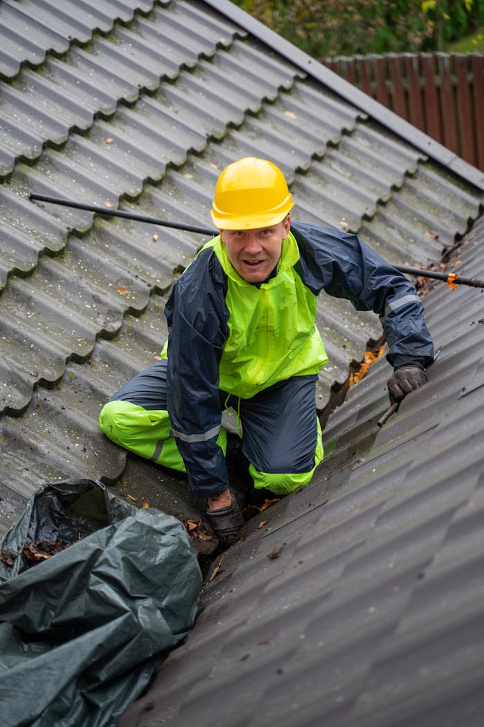 about-01 Construction worker on a rooftop ensuring safety with helmet and gear.
